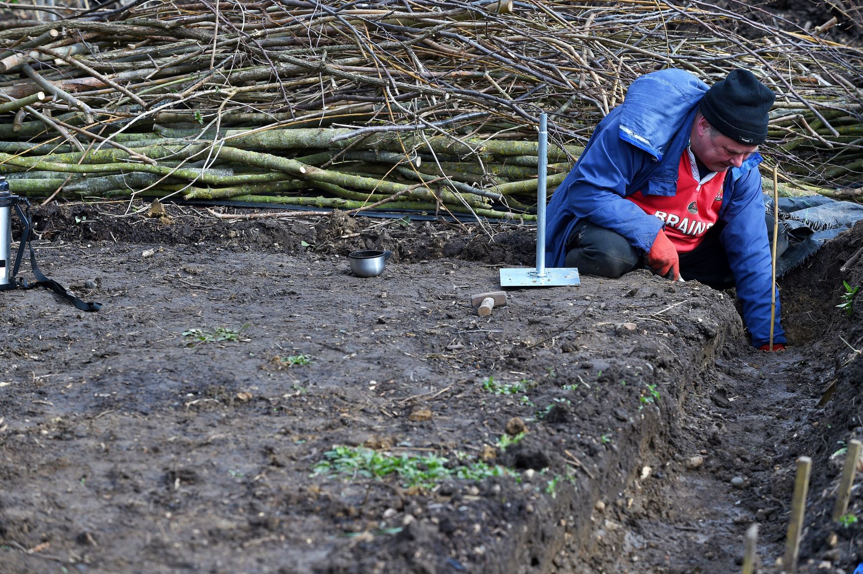 man digging drainage gully